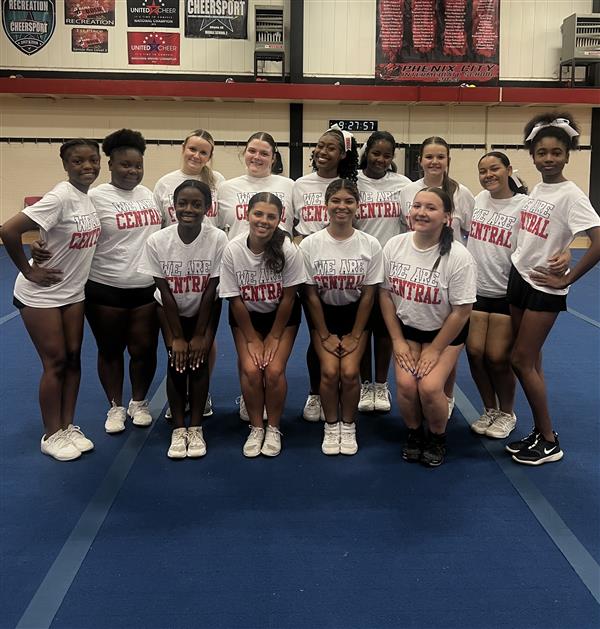 thirteen cheerleaders on blue mat at practice
